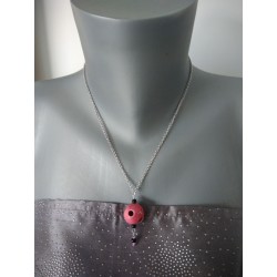 Old pink necklace and black ceramic holes on stainless steel chain.